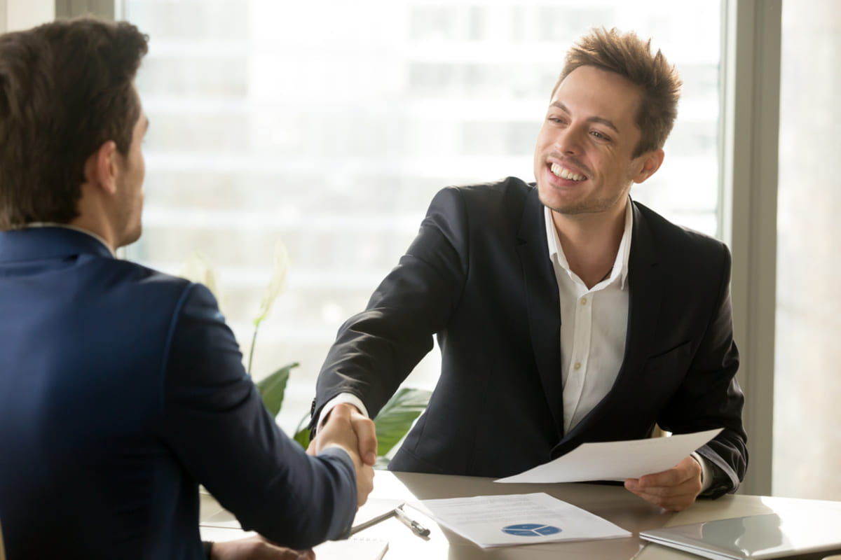 Friendly property manager and satisfied client shaking hands