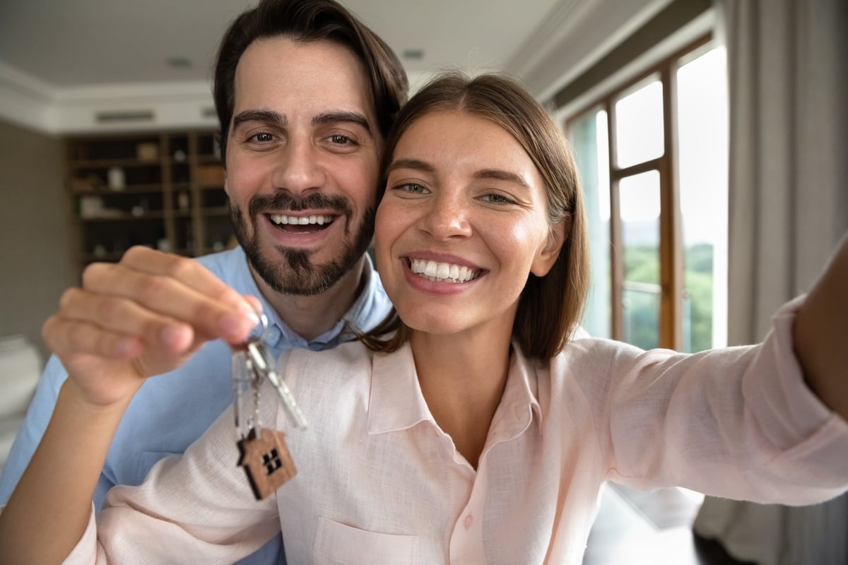 Happy tenants holding keys