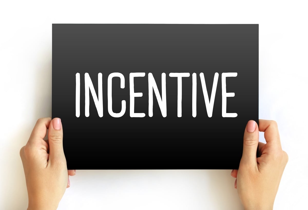 Someone holding a black card that says incentive