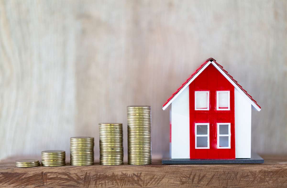 Red roof house model. Coins that are stacked from low to high. Financial and banking concepts Preparing for home purchase and real estate economic growth. Home mortgage finance