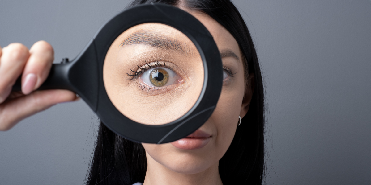 1 Woman looking through a magnifying glass